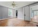 Bright bedroom with wood floors, gray walls, and a double door leading into a closet and bathroom at 10 Shadburn Ferry Rd, Buford, GA 30518