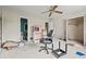An untidy bedroom features a ceiling fan, adjacent bathroom, and closet space at 10 Shadburn Ferry Rd, Buford, GA 30518