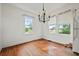 Bright dining room featuring hardwood floors, natural light, chandelier, and white walls at 10 Shadburn Ferry Rd, Buford, GA 30518