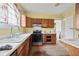 Kitchen featuring wood cabinets, white countertops, and a stainless steel sink at 10 Shadburn Ferry Rd, Buford, GA 30518