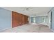 Large empty living room with outdated carpet, light blue walls, and two windows; ready for a modern makeover at 10 Shadburn Ferry Rd, Buford, GA 30518