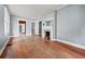 An empty living room with hardwood floors, a white fireplace and two windows, ready for your personal touch at 10 Shadburn Ferry Rd, Buford, GA 30518