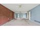 Large empty living room with outdated carpet, light blue walls, and two windows; ready for a modern makeover at 10 Shadburn Ferry Rd, Buford, GA 30518