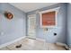 Mud Room features tile floors, beadboard trim, window with blinds, and a door to the backyard at 10 Shadburn Ferry Rd, Buford, GA 30518