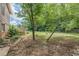 View of the yard with mature trees, patio, and access to the wooden deck at 1737 Fontaine Dr, Jonesboro, GA 30236