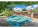 View of the backyard with a covered pool, a wooden fence, and a deck off of the home at 1737 Fontaine Dr, Jonesboro, GA 30236