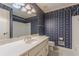 Full bathroom with a large mirror, striped wallpaper, and a combination tub and shower at 1737 Fontaine Dr, Jonesboro, GA 30236