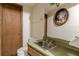 Powder room with a mirrored vanity, light fixtures, a flower painting, a sink, and toilet at 1737 Fontaine Dr, Jonesboro, GA 30236