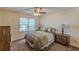 Bedroom features carpet, a ceiling fan, and a bright window at 1737 Fontaine Dr, Jonesboro, GA 30236