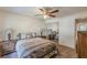 Comfortable bedroom featuring neutral walls, ceiling fan, and mirrored closet doors at 1737 Fontaine Dr, Jonesboro, GA 30236