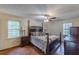 Spacious bedroom featuring hardwood floors, a ceiling fan, and two windows at 1737 Fontaine Dr, Jonesboro, GA 30236