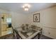 The dining room showcases a glass-top table and leads into the vintage-style kitchen at 1737 Fontaine Dr, Jonesboro, GA 30236