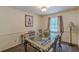 Classic dining room with a large glass top table, artwork, and a floor lamp at 1737 Fontaine Dr, Jonesboro, GA 30236