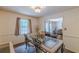 Cozy dining room features a glass-top table, elegant chairs, and natural light from the window at 1737 Fontaine Dr, Jonesboro, GA 30236