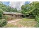 Charming brick home featuring a cozy covered porch with decorative railing and landscaped lawn at 1737 Fontaine Dr, Jonesboro, GA 30236