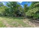 Two-story home with brick chimney surrounded by lush trees on a large lawn at 1737 Fontaine Dr, Jonesboro, GA 30236