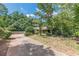 Brick home with a covered porch and an extended driveway surrounded by trees and green space at 1737 Fontaine Dr, Jonesboro, GA 30236