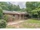 Charming brick home featuring a cozy covered porch with decorative railing and landscaped lawn at 1737 Fontaine Dr, Jonesboro, GA 30236