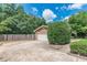 View of a home's garage with a fenced yard and partial view of the extended driveway at 1737 Fontaine Dr, Jonesboro, GA 30236