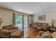 Comfortable living room with hardwood floors, a sliding glass door to a deck, and cozy furnishings at 1737 Fontaine Dr, Jonesboro, GA 30236