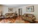 Traditional living room with hardwood floors, plush sofas, and decorative wall art at 1737 Fontaine Dr, Jonesboro, GA 30236