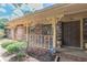 Covered brick porch featuring a security system sign, decorative railing, and double door entry at 1737 Fontaine Dr, Jonesboro, GA 30236