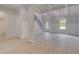 Open-concept living space with tray ceiling, showcasing hardwood floors, staircase and white trim and molding at 197 Haverling Pass, Hampton, GA 30228