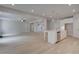 Open floor plan showcasing kitchen and living areas, featuring hardwood floors, ample natural light, and modern finishes at 197 Haverling Pass, Hampton, GA 30228