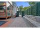 Beautiful backyard featuring brick paving, stone seating, and a glass-enclosed structure by the pool area at 1060 Mcdaniel Sw St, Atlanta, GA 30310