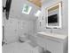 Modern white bathroom features marble floors, skylight, and glass shower at 1060 Mcdaniel Sw St, Atlanta, GA 30310