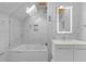 Beautiful bathroom featuring white marble tile, sleek vanity, and a glass-enclosed shower-tub combo at 1060 Mcdaniel Sw St, Atlanta, GA 30310