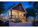 Charming home exterior with a covered porch, illuminated stairs, and a brick driveway leading to the house at 1060 Mcdaniel Sw St, Atlanta, GA 30310