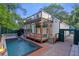 Stunning home exterior with a glass-enclosed structure, a swimming pool, and a beautifully landscaped yard at 1060 Mcdaniel Sw St, Atlanta, GA 30310