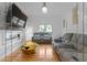 Spacious living room featuring a modern fireplace, hardwood floors, and an open floor plan to the outdoor patio at 1060 Mcdaniel Sw St, Atlanta, GA 30310