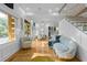 Bright living room features an open floor plan to the dining room and kitchen, and has hardwood floors and a glass stairway at 1060 Mcdaniel Sw St, Atlanta, GA 30310