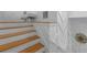 Staircase with oak treads, white risers and walls with herringbone pattern at 1060 Mcdaniel Sw St, Atlanta, GA 30310