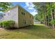 Expansive back yard with a two-story tan home with a partial view of the side of the house at 7567 Waverly Loop, Fairburn, GA 30213