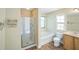 Bright bathroom with tub, separate shower, and vanity with wood cabinets at 7567 Waverly Loop, Fairburn, GA 30213