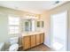 Bright bathroom with tub, single vanity and walk-in closet at 7567 Waverly Loop, Fairburn, GA 30213