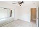 Bedroom with neutral carpet, ceiling fan, closet, and a doorway for convenient access to other rooms at 7567 Waverly Loop, Fairburn, GA 30213