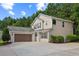 Charming two-story home with a two car garage, manicured lawn and lush landscaping at 7567 Waverly Loop, Fairburn, GA 30213