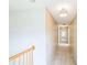 Neutral hallway with carpet flooring and access to multiple rooms at 7567 Waverly Loop, Fairburn, GA 30213