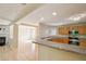 Kitchen with stone countertop, stainless steel appliances, light wood cabinets, and decorative ceiling at 7567 Waverly Loop, Fairburn, GA 30213