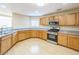 Spacious kitchen features modern appliances, gray countertops, and wood flooring at 7567 Waverly Loop, Fairburn, GA 30213