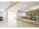 Bright, open kitchen with wood cabinets, granite countertops, and stainless steel appliances at 7567 Waverly Loop, Fairburn, GA 30213