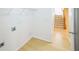 A laundry room with washer hookups, storage rack and a view of the staircase at 7567 Waverly Loop, Fairburn, GA 30213
