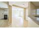 Bright open floor plan with view of the living room fireplace and breakfast bar with stone countertop at 7567 Waverly Loop, Fairburn, GA 30213