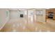 Open floor plan showcasing the fireplace, breakfast bar, wood floors and view of the kitchen at 7567 Waverly Loop, Fairburn, GA 30213
