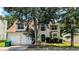 Charming two-story home featuring a well-maintained front yard, classic shutters and an attached two-car garage at 3679 Waldrop Cliff Ln, Decatur, GA 30034
