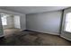 Bright living room featuring neutral paint, plush carpeting, and a seamless transition to the adjacent dining area at 3679 Waldrop Cliff Ln, Decatur, GA 30034
